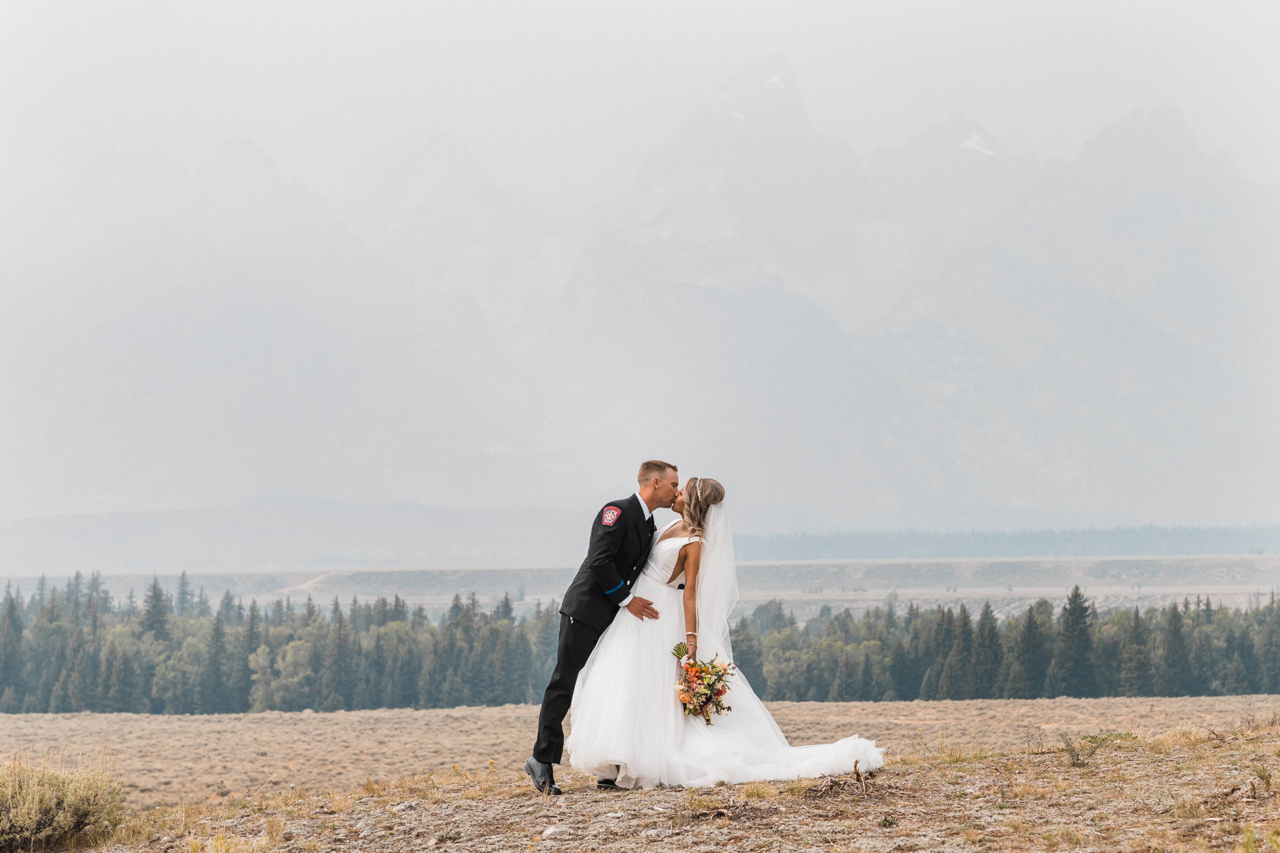 Bride and groom kiss for couple photos for wedding in Grand Teton National Park