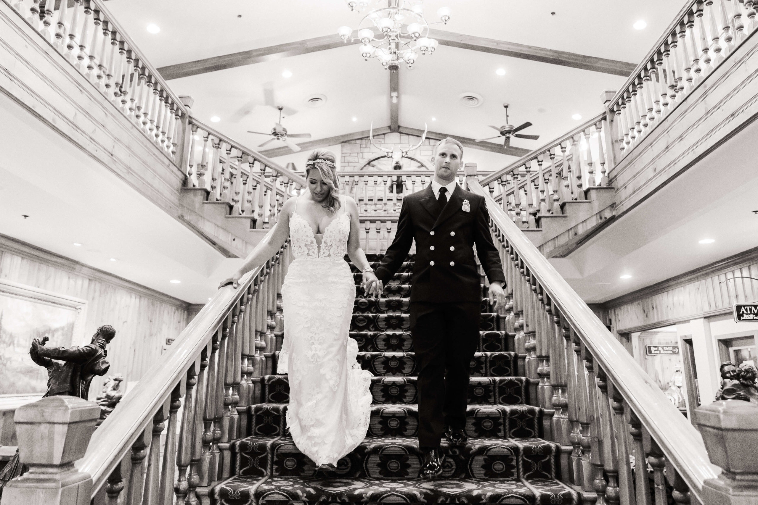 Bride and groom walking down the staircase at The Wort Hotel