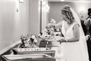 Bride dishing up food at small wedding dinner reception
