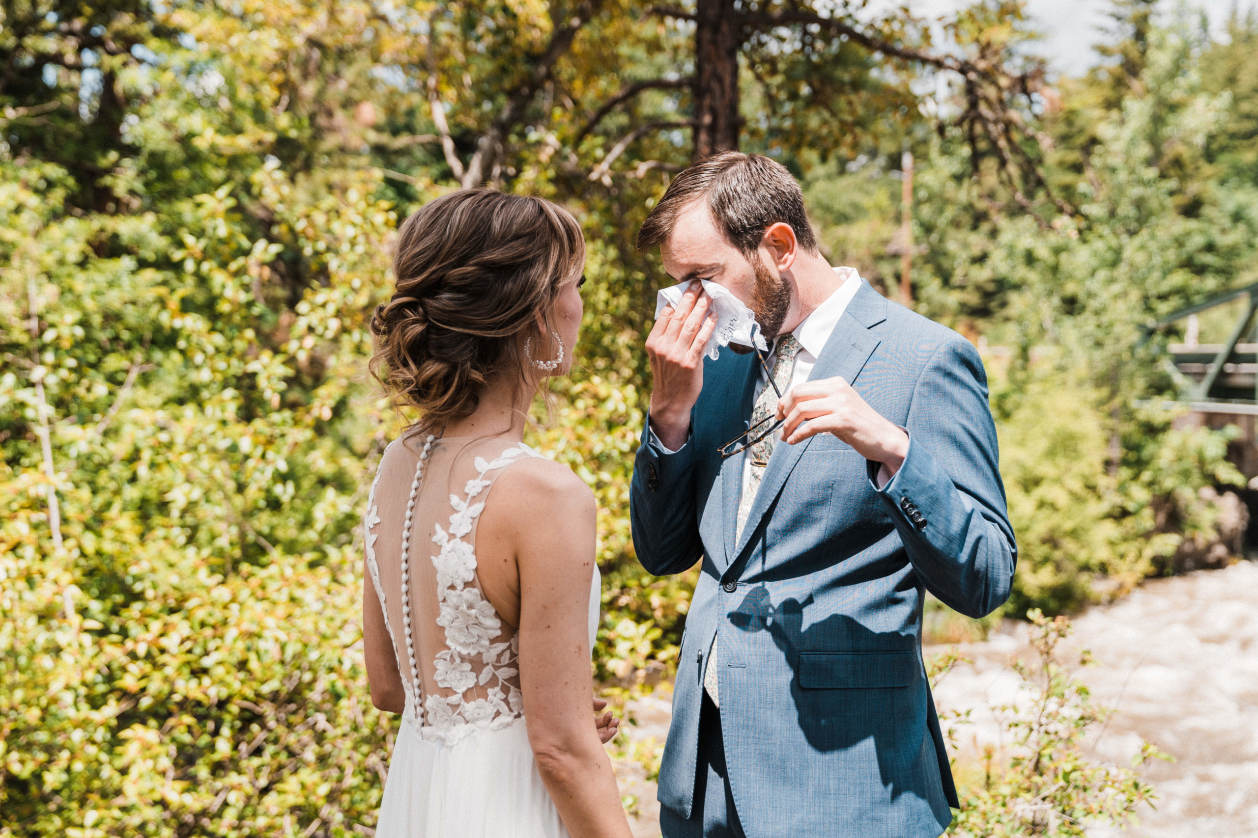Groom crying and wiping his eyes after first look at Hood River wedding