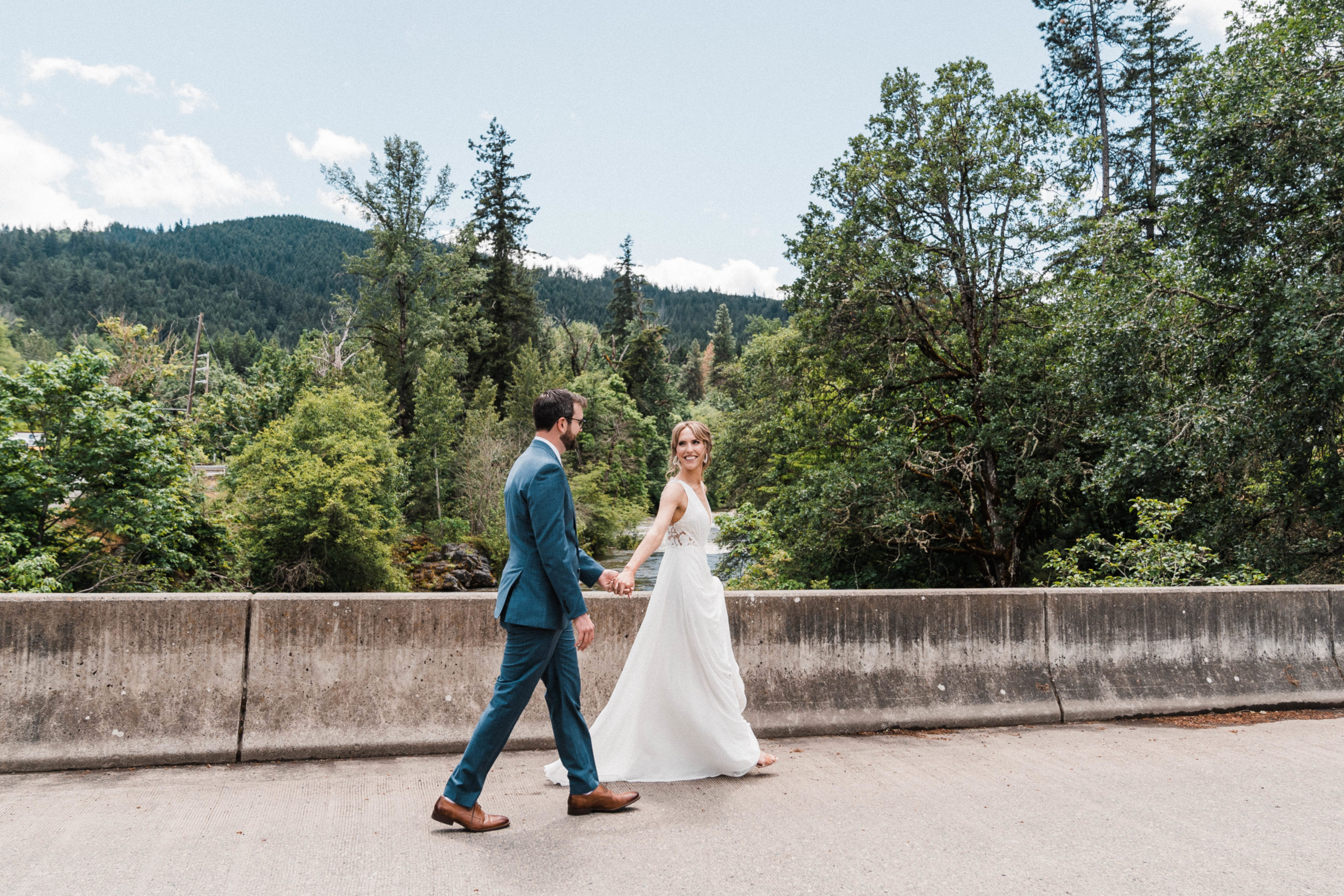 Bride and groom walking along the bridge at Hood River, Oregon