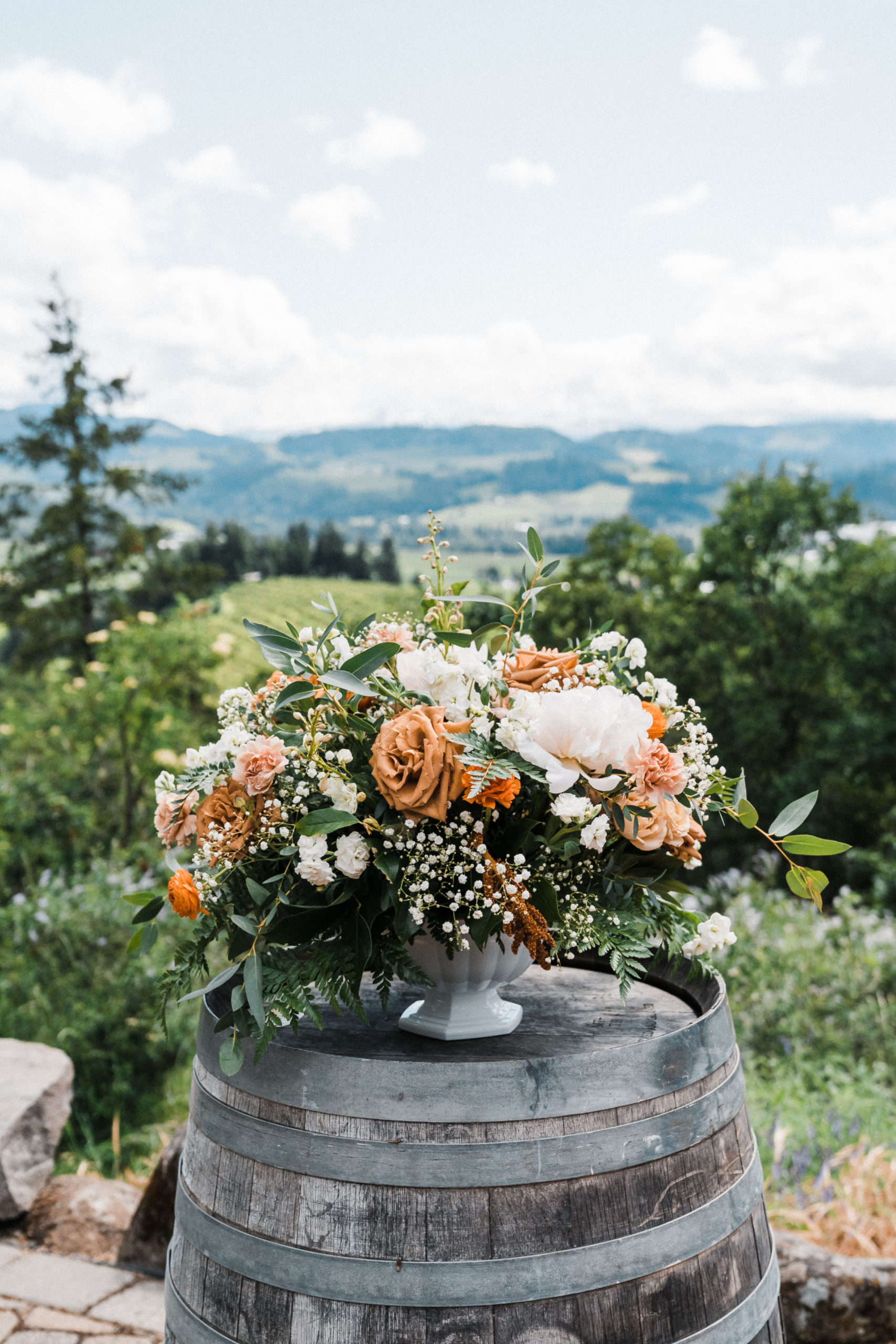 Orange, white and green floral arrangement at Hood River wedding