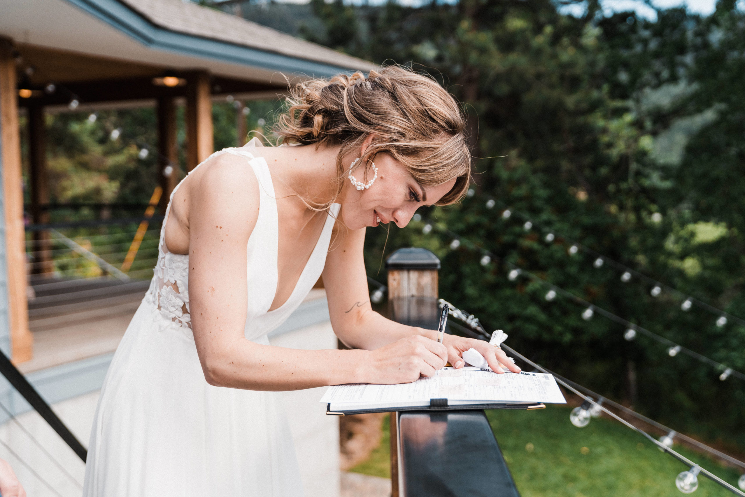 Bride signing marriage license at intimate Hood River wedding