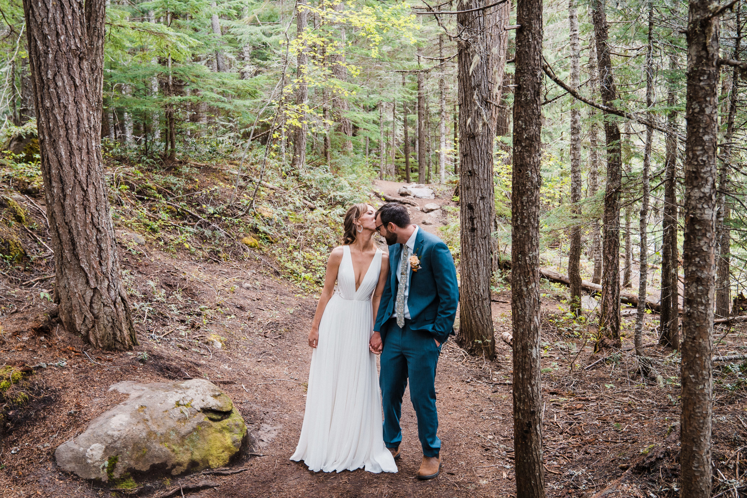 Bride and groom walking a forest trail during Oregon wedding in Hood River