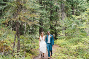 Bride and groom walking along a forest trail during Oregon Wedding in Hood River
