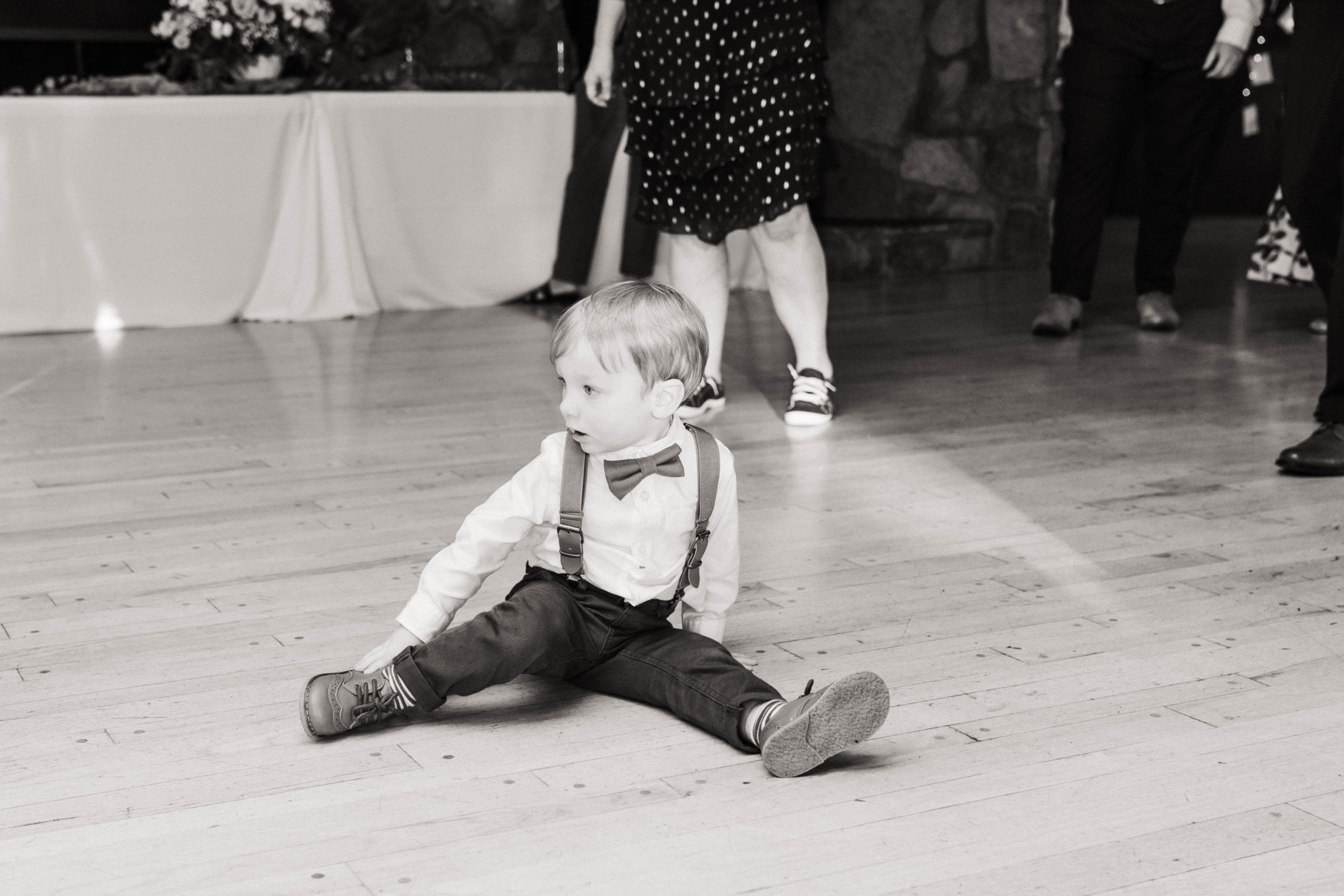 Toddler boy sitting on the dance floor at intimate Oregon wedding