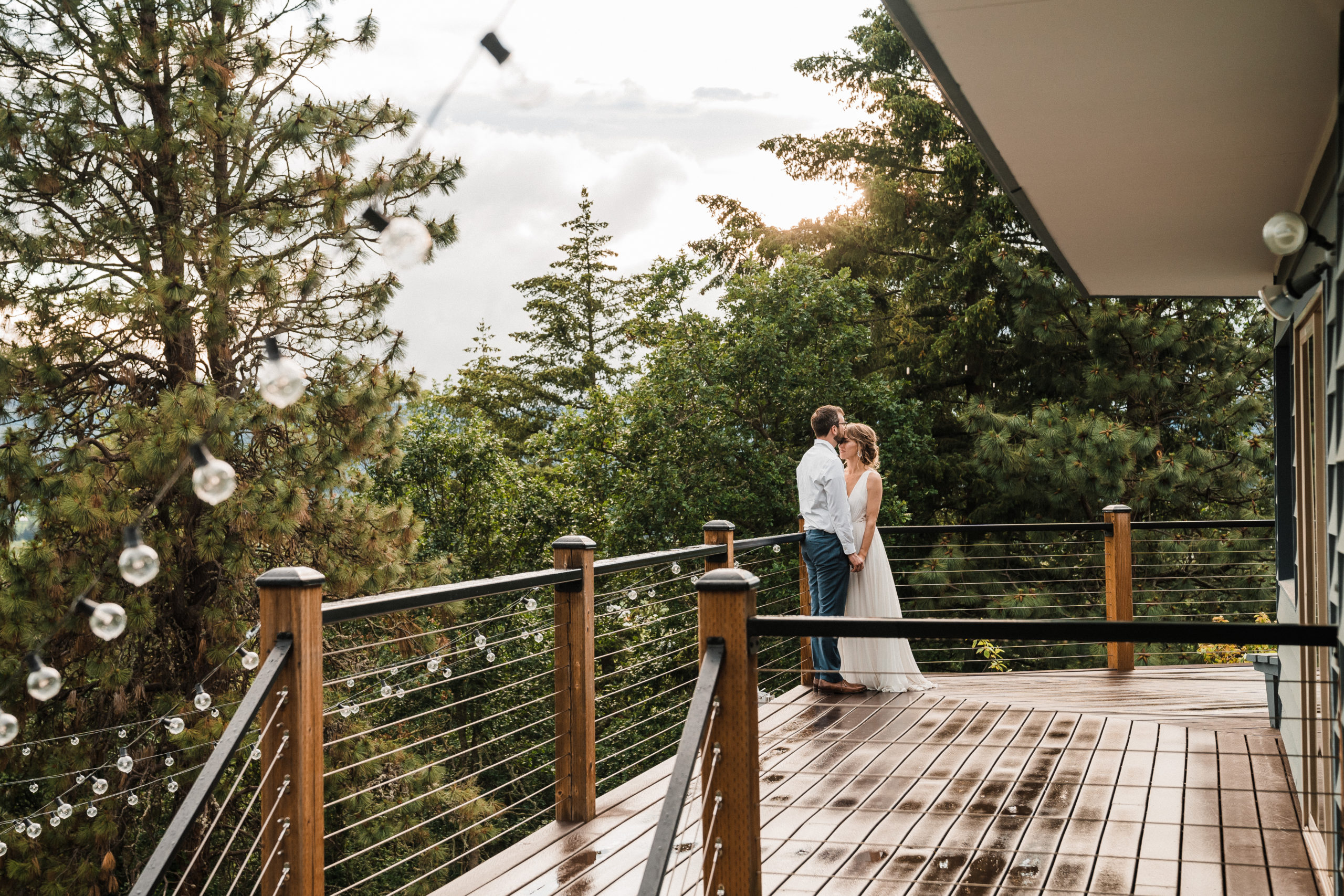 Bride and groom standing on the deck at Hood River wedding in Oregon