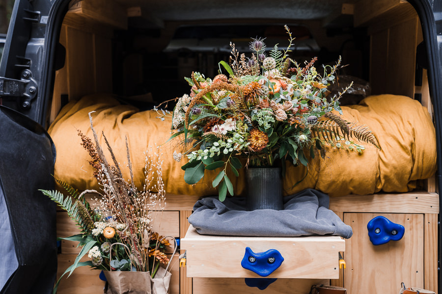 large floral arrangement for elopement in a camper van