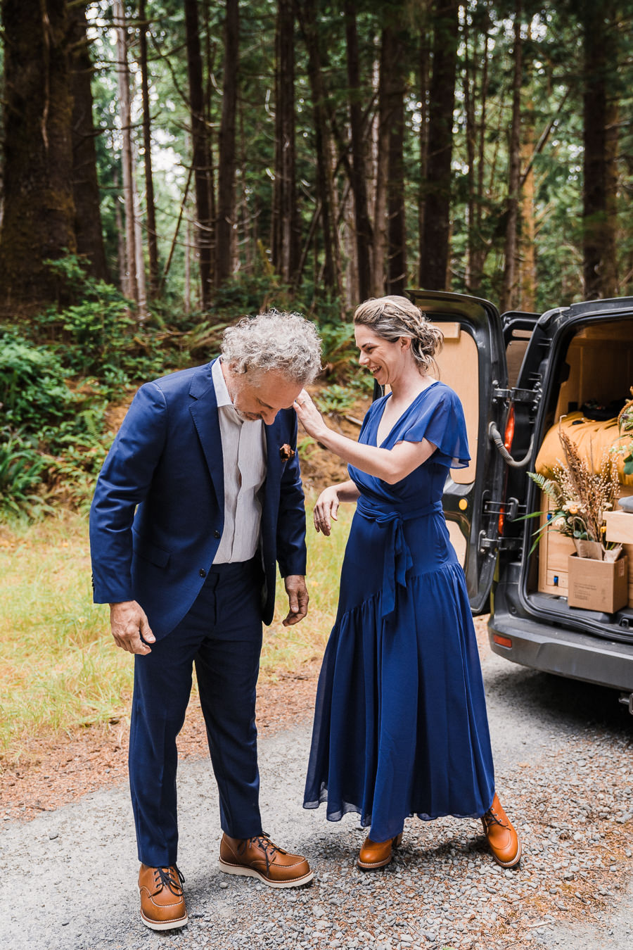Bride helps her groom get ready for their elopement
