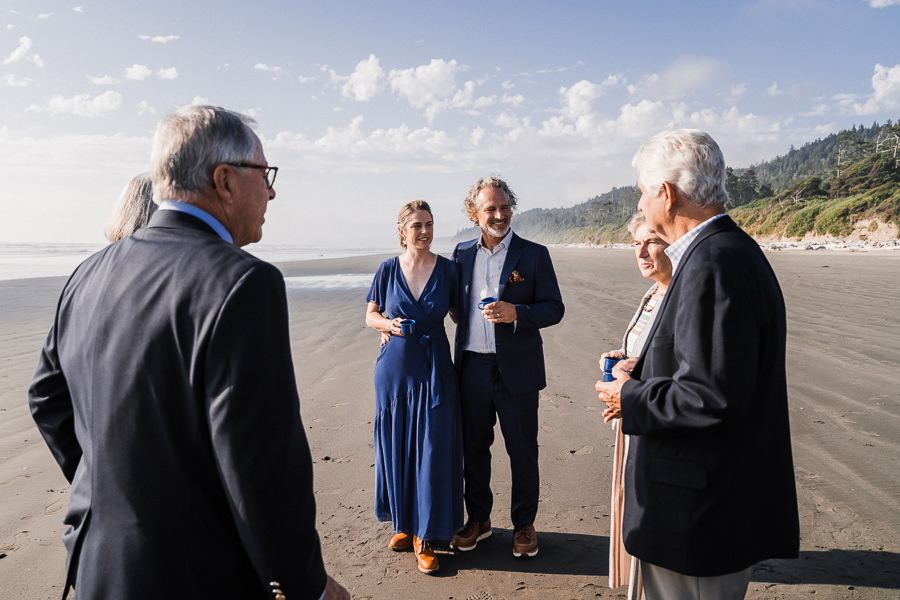 Bride and groom converse with their family after their Washington coast elopement