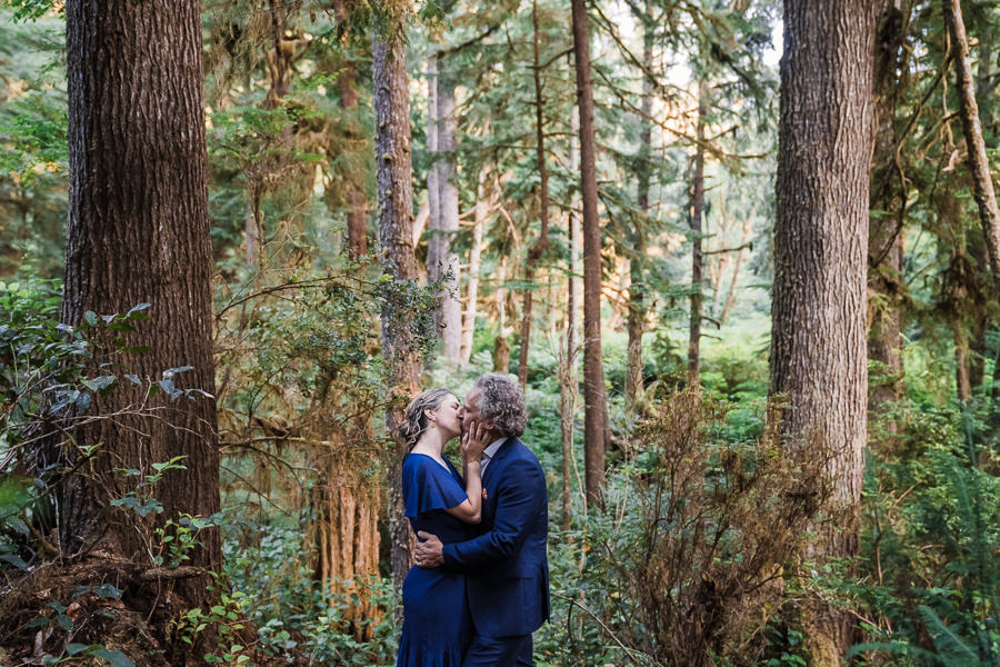 Bride and groom share a kiss in the woods in Olympic National Park