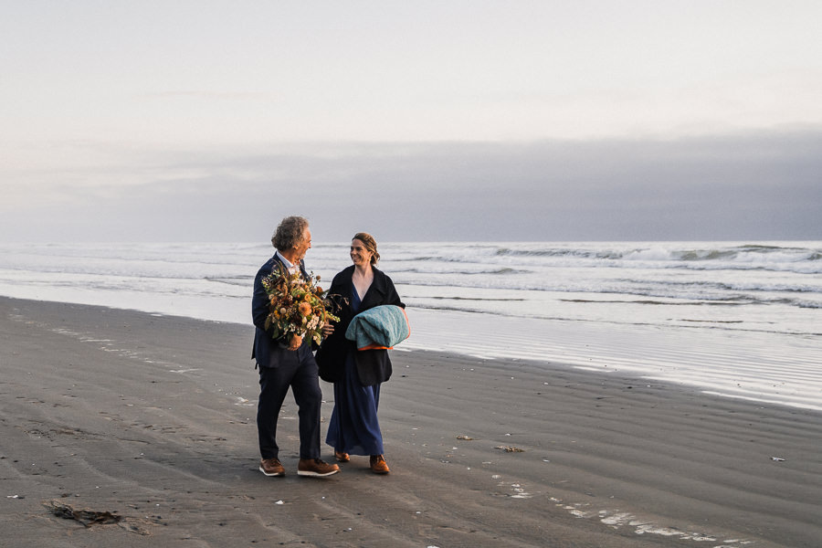 Bride and groom walk on Kalaloch Beach after their Olympic National Park elopement