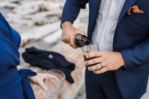 Groom pours a beer for his bride