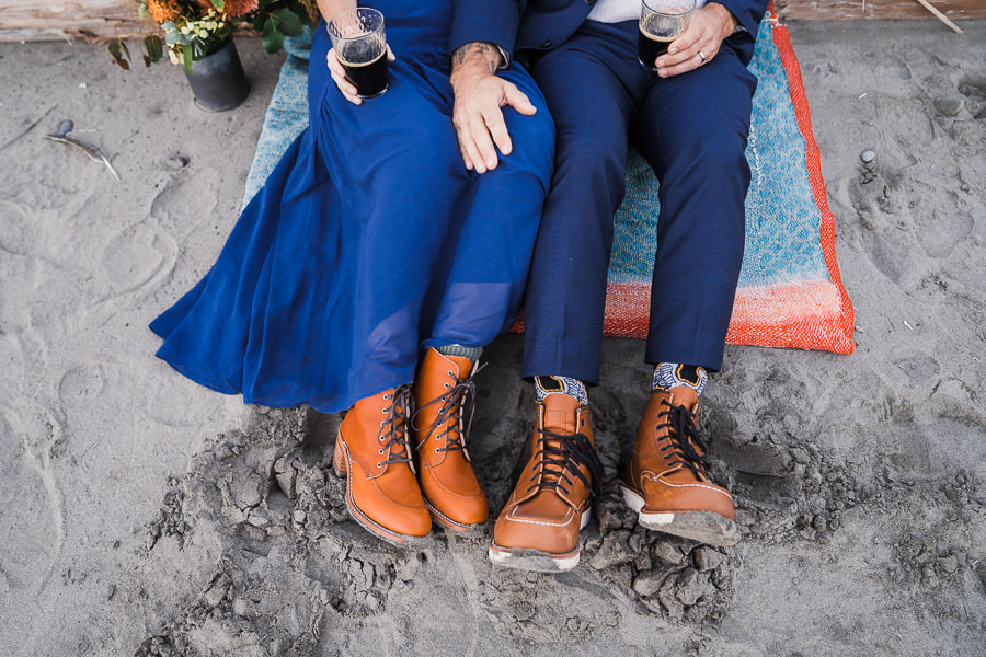 Bride and groom both wearing blue wedding attire and brown leather hiking boots