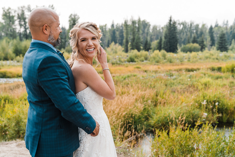 a bride looks back toward the camera during her grand teton national park elopement