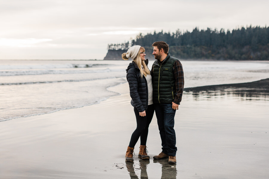 a couple stands together on the north coast of Washington during their engagement photos