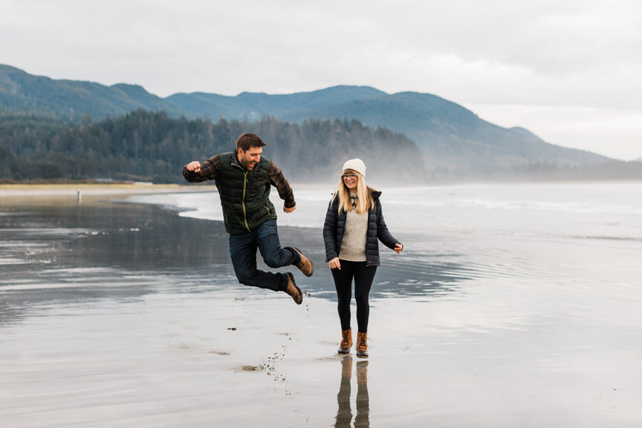 a man does a heel kick while walking with his partner on the Washington coast